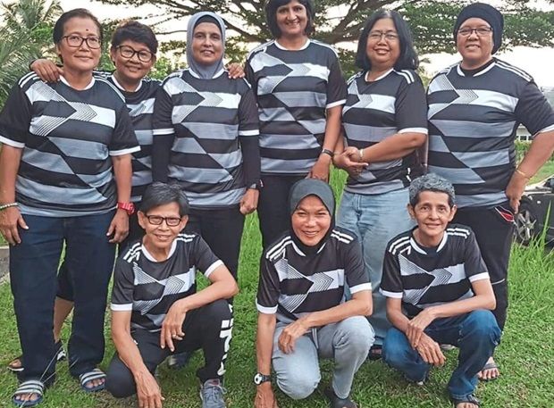 Bosom buddies: Normala Rashid (front row, middle) reunited with her old national teammates before a friendly match.