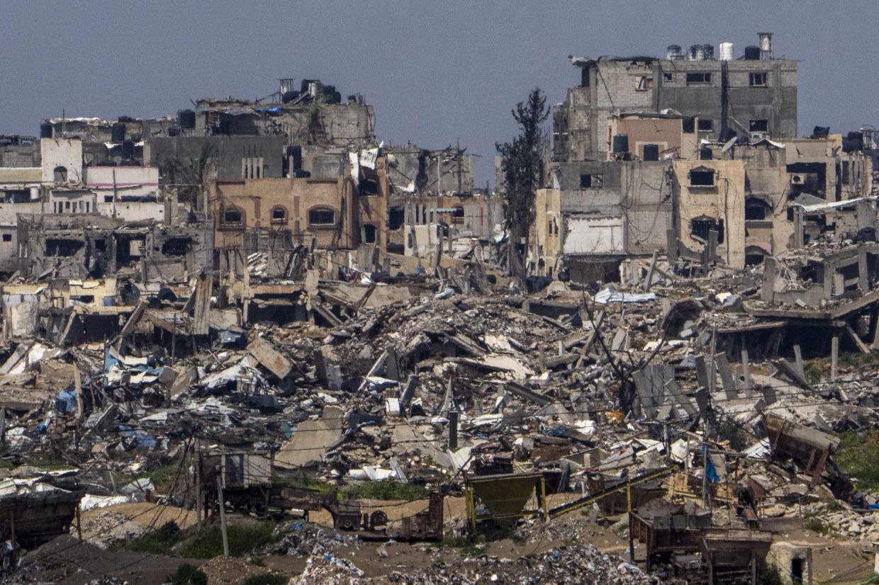 Destroyed buildings stand inside Gaza Strip, as seen from southern Israel, Tuesday, March 19, 2024. - AP