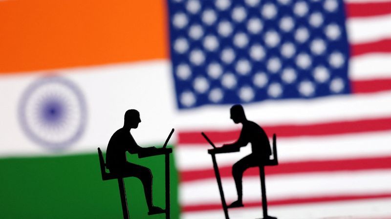 The Indian flag the U.S. flag and people miniatures with laptops are seen in this illustration taken March 10 2024. REUTERSDado RuvicIllustration
