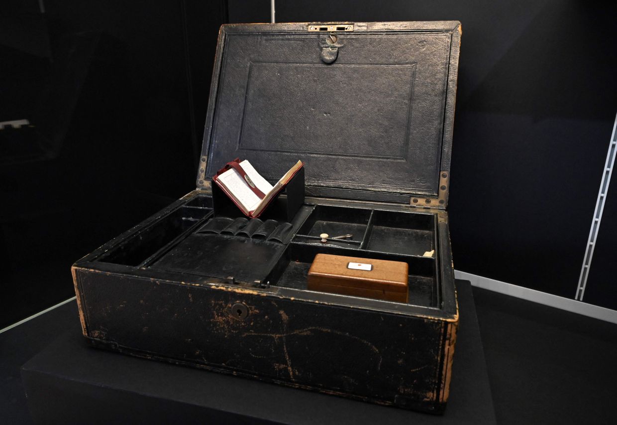 Wilkie Collins' brass-bound black leather writing desk, mid-19th century, is pictured at the exhibition 'Murder By The Book' at the Cambridge University Library. Photo: AFP 
