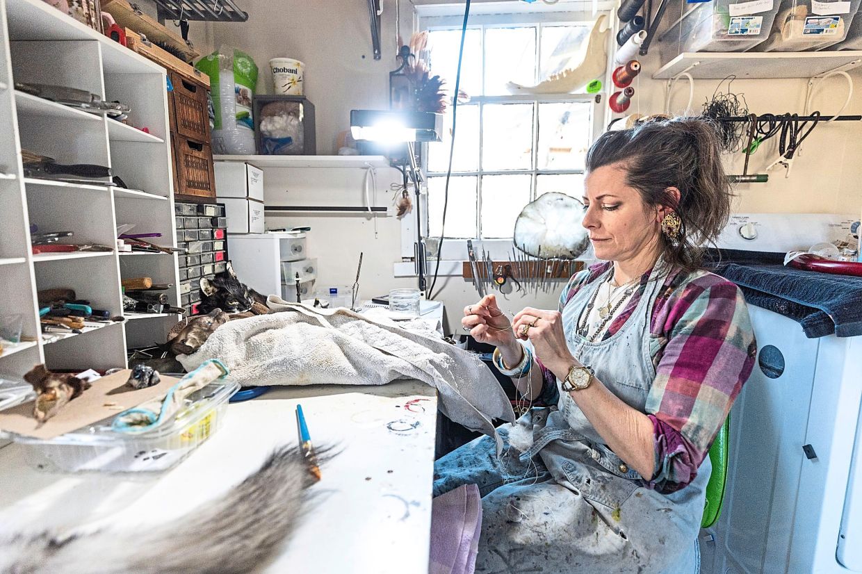 Beth Beverly sews a cat’s tail for a client in her workspace in Elkins Park, Pennsylvania, the United States.