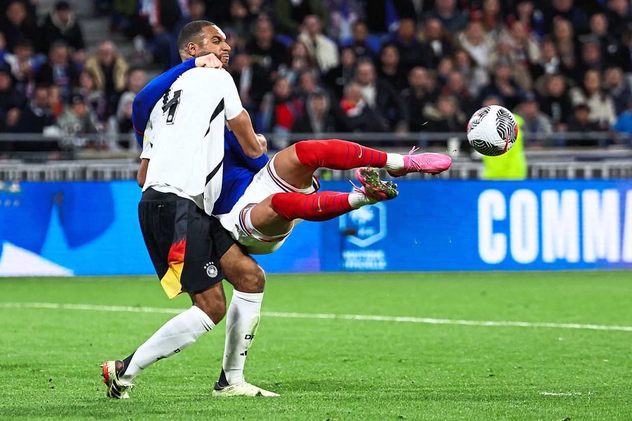 Germany defender Jonathan Tah fights for the ball with France’s Olivier Giroud during the friendly on March 23. The Germans overcame the French 2-0 in a confidence-boosting win ahead of hosting Euro 2024. — AFP