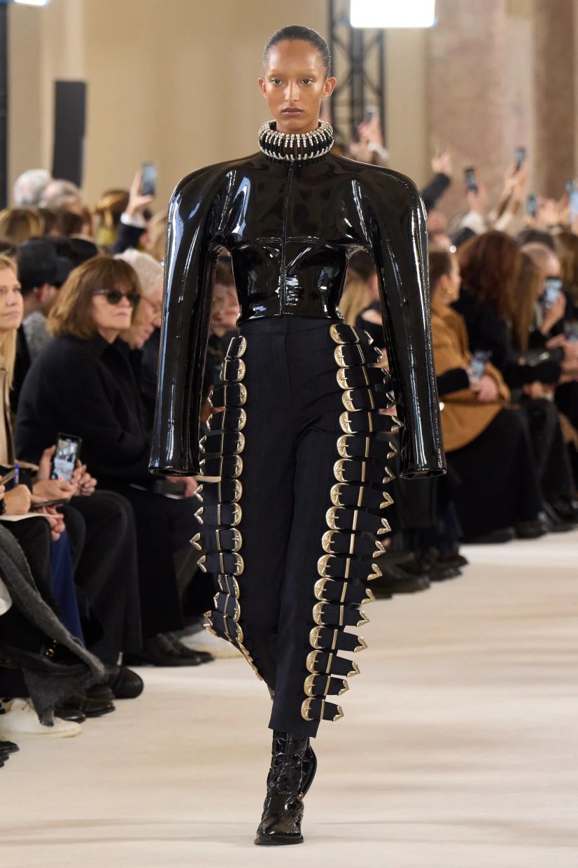 Schiaparelli's Spring/Summer 2024 couture banked on the country aesthetic. Shown here is a model wearing a pair of pants completely covered with cowboy-inspired silver-plated buckles, and patent black leather cowboy boots. Photo: Schiaparelli