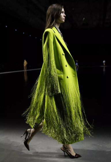 Get glamorous with the fringe trend by embellishing an acid green coat with glittering fringe that catches the eye with its sparkling allure. Photo: Gucci