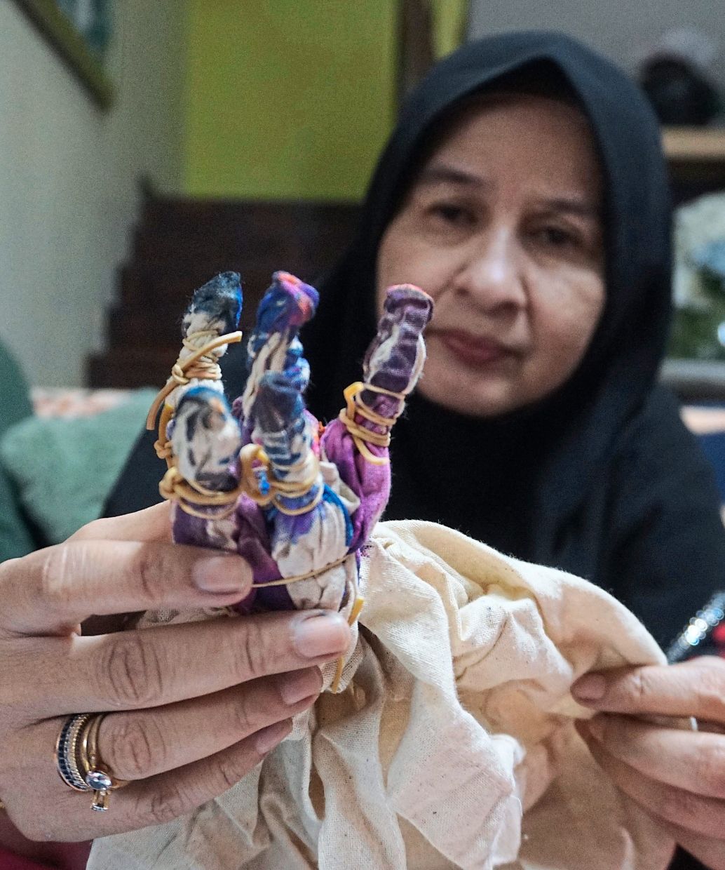 Using skills she learned from her art and design diploma, Noor Atikah ties and dyes trendy designs that are beginning to capture interest from shoppers. — Photos: Bernama
