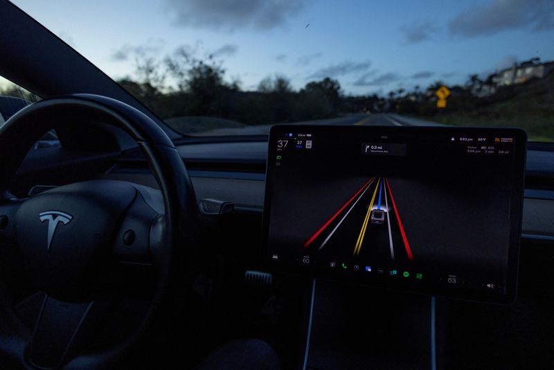 A Tesla Model 3 vehicle is shown using the Full Self Driving Beta software FSD while navigating a city road in Encinitas California U.S. February 28 2023. REUTERSMike BlakeFile Photo