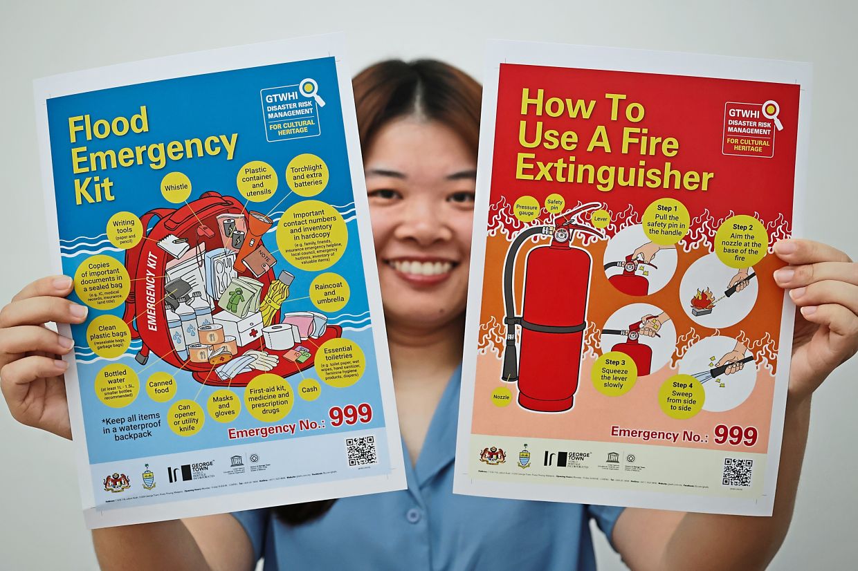 Ng with some of the disaster risk management posters created to raise awareness.