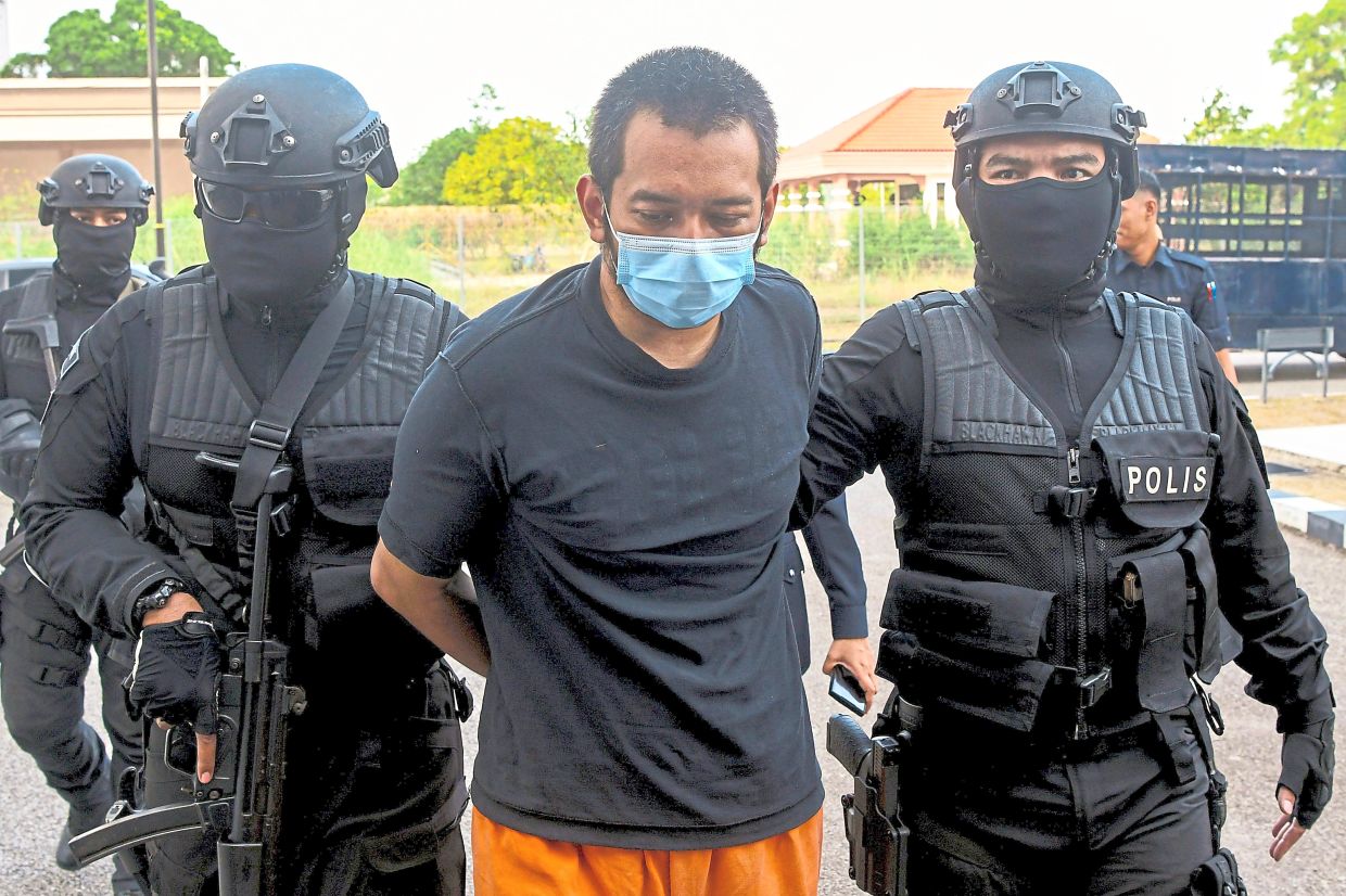 Day in court: Hafizul being brought to the Sessions Court in Kota Baru, Kelantan. — Bernama