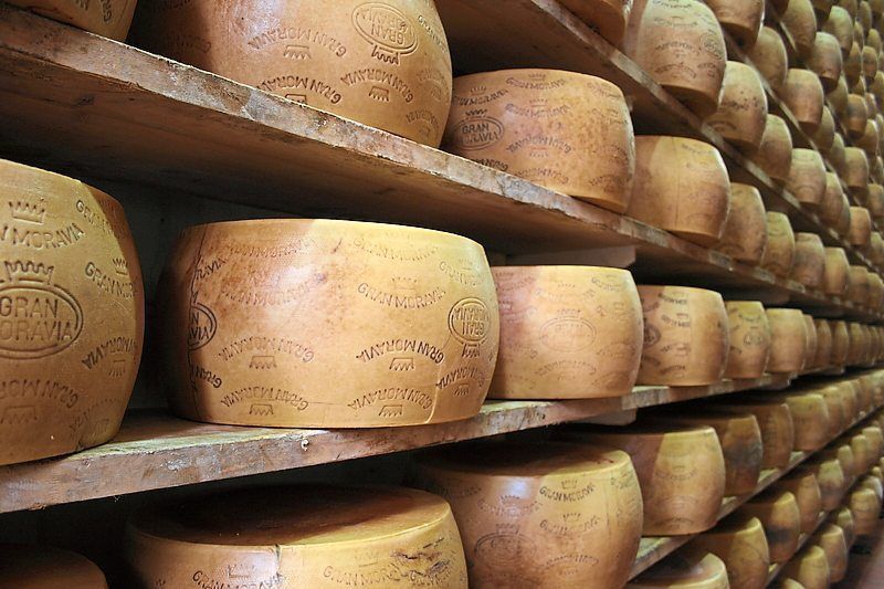 Several wheels of Gran Moravia cheese lie in a Brazzale warehouse. Photo: Brazzale AG/dpa