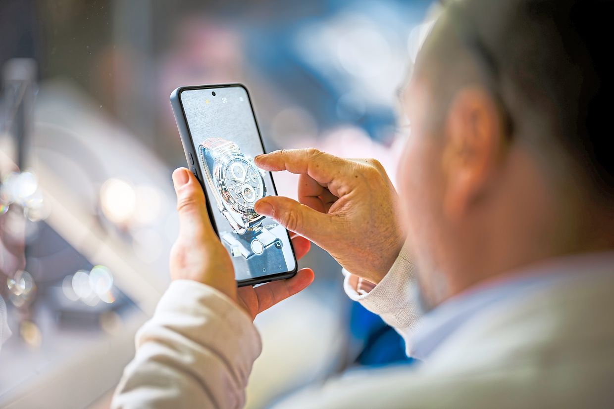 A visitor admiring the intricacies of a watch.