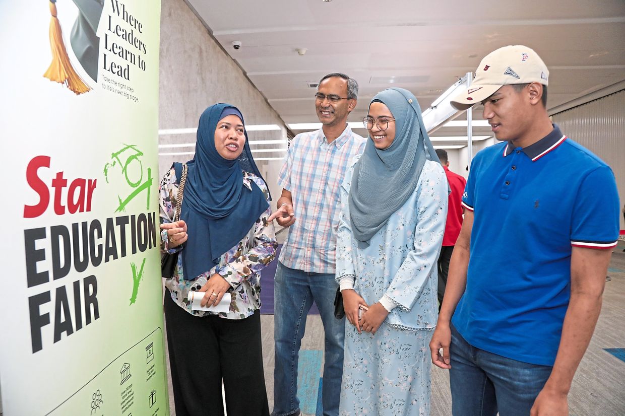 Early birds: Ameera and Muhammad Ameerul with their parents Azleen Abdul Rahman and Ruslan Md Salleh visiting the Star Education Fair 2024 at IOI Grand Exhibition and Convention Centre. — YAP CHEE HONG/The Star