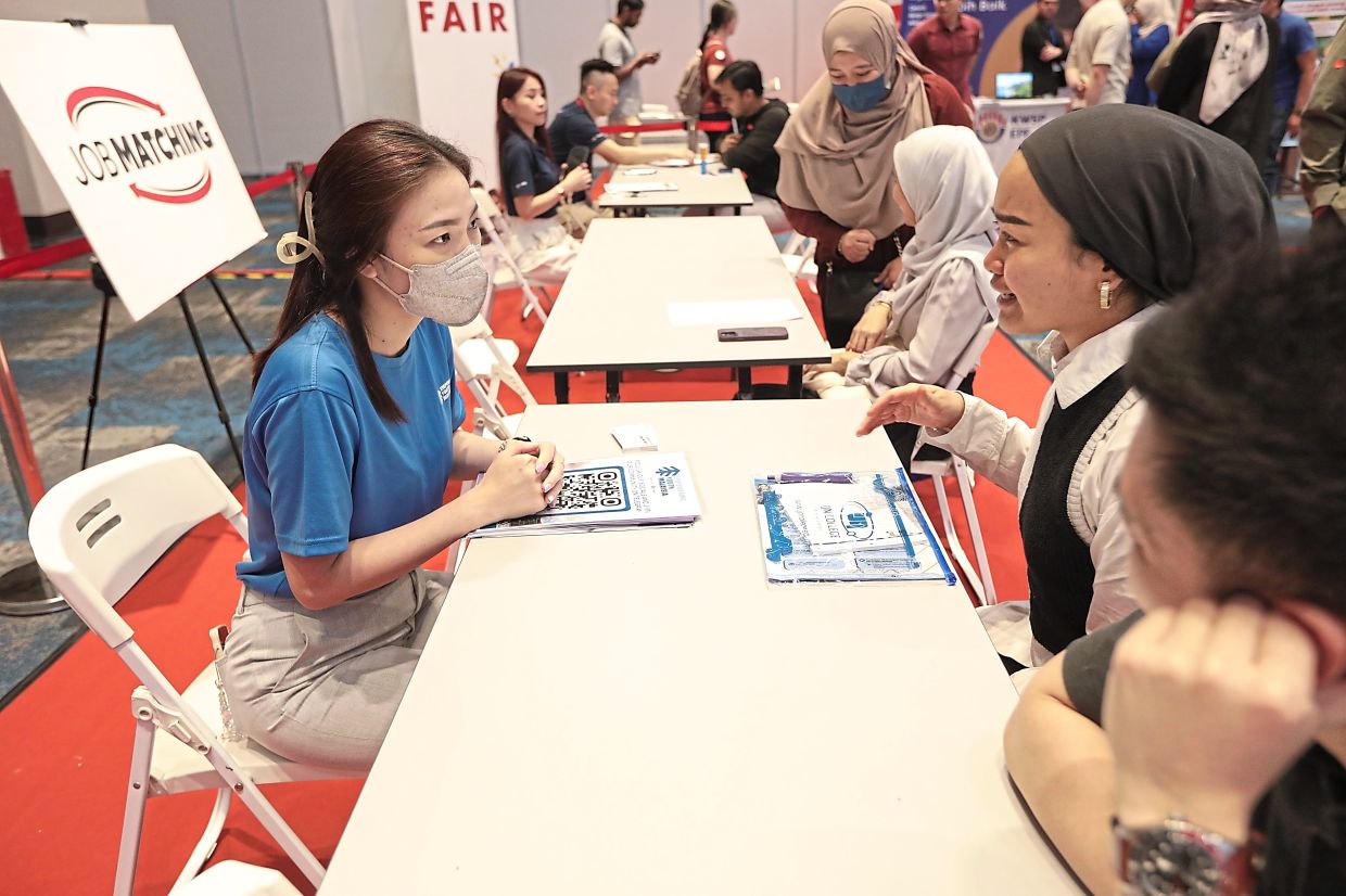 Prospective candidates: Job seekers meeting recruiters at IOI Grand Exhibition and Convention Centre in Putrajaya. — YAP CHEE HONG/The Star