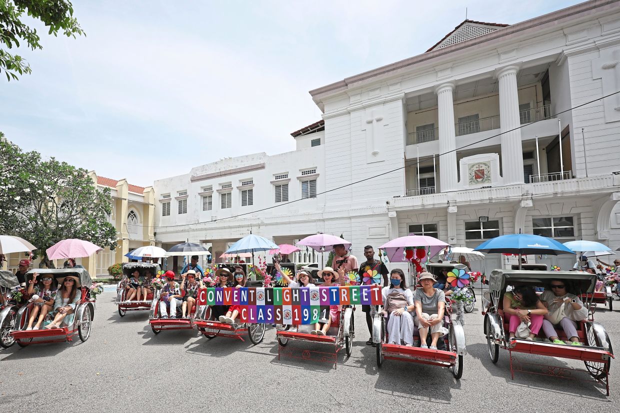The alumnae chartered 20 trishaws to explore the city as a way of evoking childhood memories of travelling to and from school. — Photos: CHAN BOON KAI/The Star