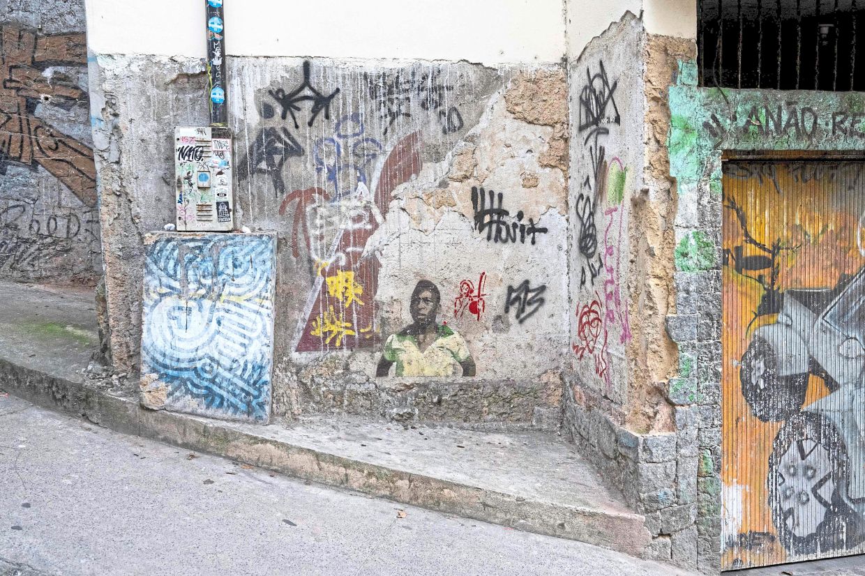 Street art depicting former Brazilian football star Pele is seen on a street leading into the Morro da Babilonia favela in Rio de Janeiro. — AFP