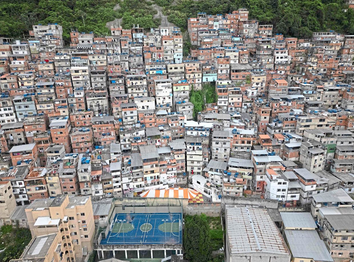 Aerial view of a tent (centre bottom) set up in the Pavao-Pavaozinho-Cantagalo favela for fans of the Flamengo and Vasco Da Gama teams to watch the Carioca derby match on a giant screen in Rio de Janeiro taken on Feb 4. — AFP