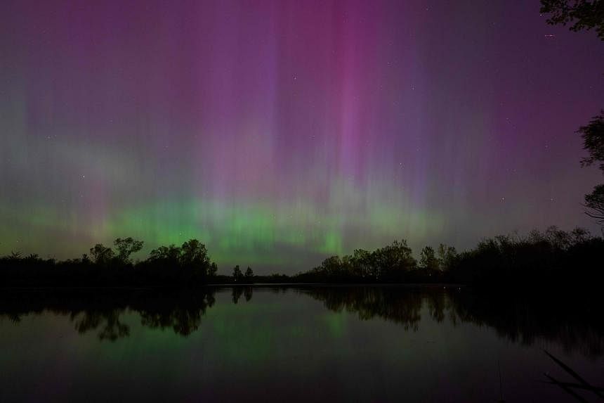 An aurora borealis illuminate the night sky near London, Ontario, during a geomagnetic storm on May 10. - PHOTO: AFP