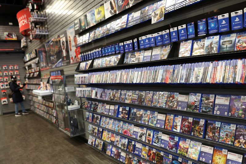 A person browses games in a GameStop in Manhattan New York U.S. December 7 2021. REUTERSAndrew KellyFile Photo