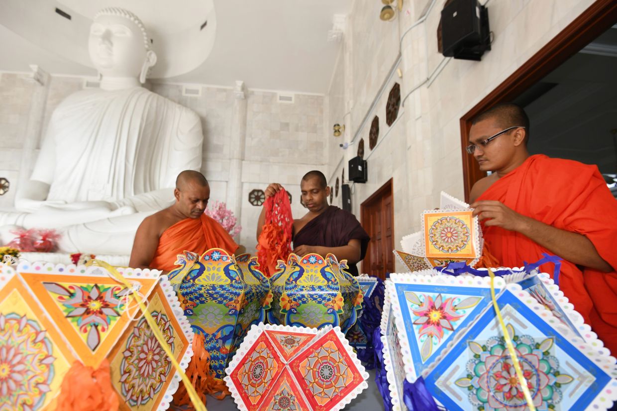 Buddhist monks from Sri Lanka tying lanterns that will be put up around the Sri Jayanti Buddhist Temple in Sentul, Kuala Lumpur. — ONG SOON HIN/The Star