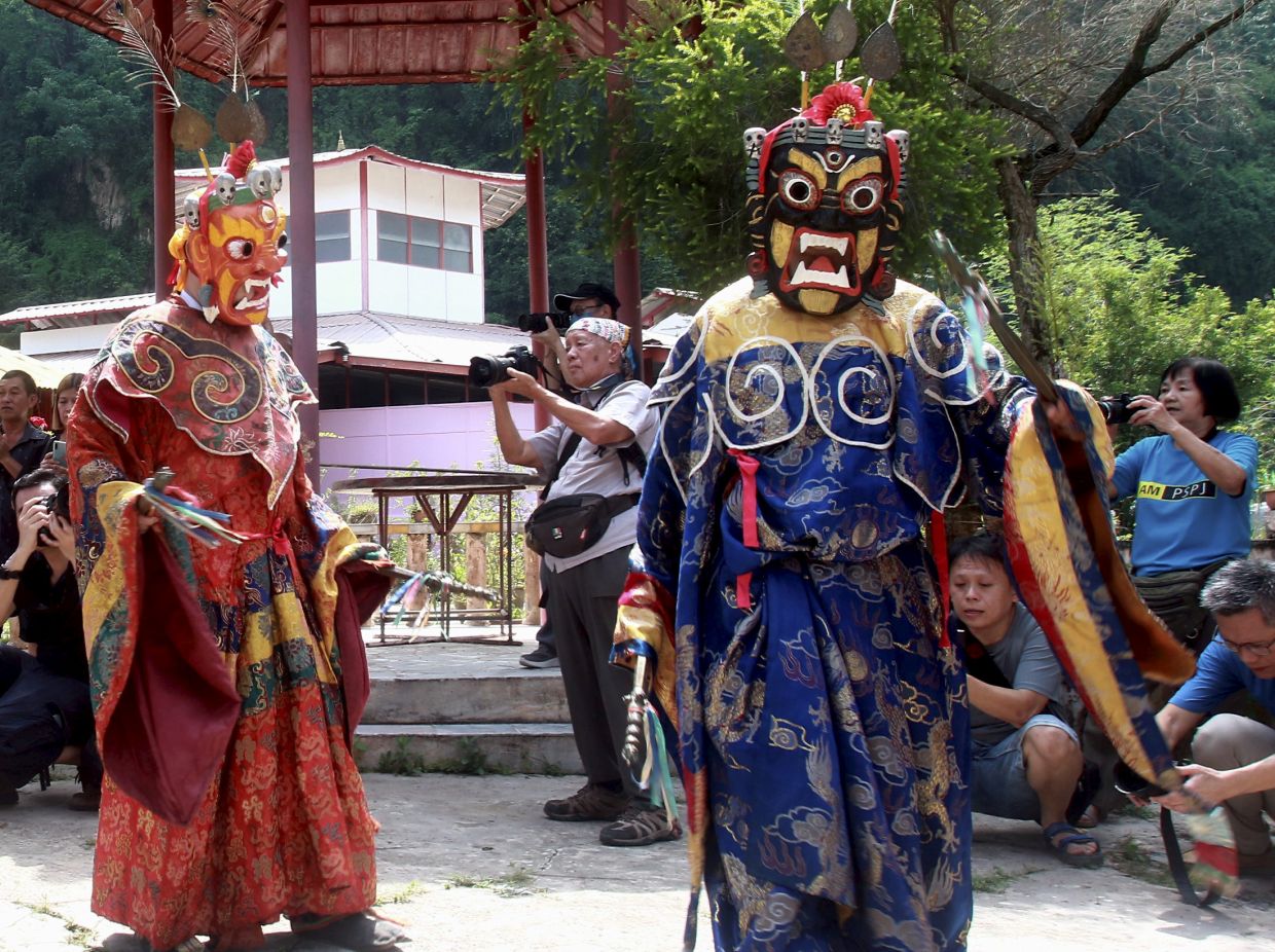 Buddhist devotees dressed in Tibetan deity costumes lead a procession at the Enlightened  Heart Buddhist Temple in Tambun near Ipoh Perak in conjunction with Wesak Day conjunction.RONNIE CHIN/The Star