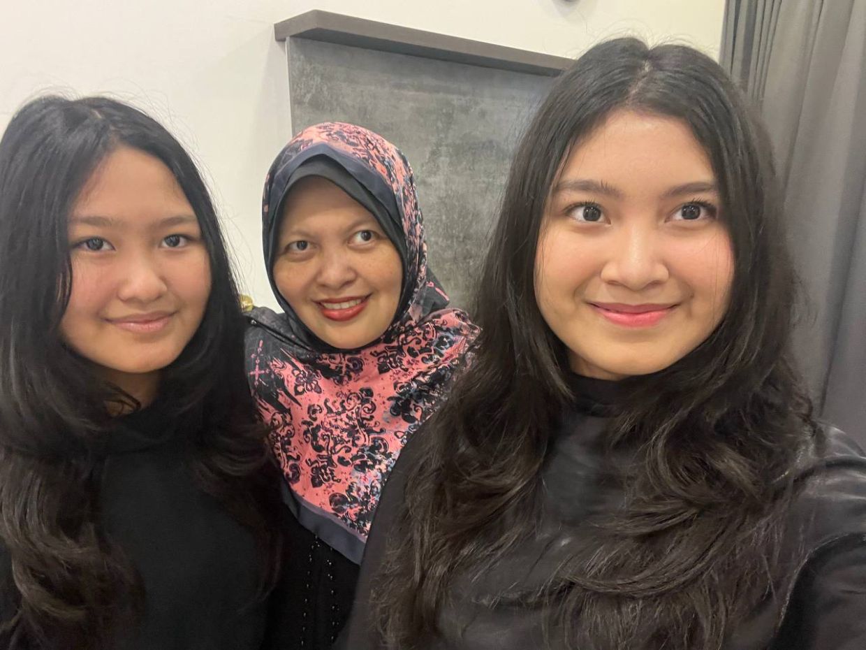 Mazlin Norman (centre) with her daughters Nur Sarah Nisrina Jamal (left) and Nur Shana Fariha Jamal. Photo: Mazlin Norman