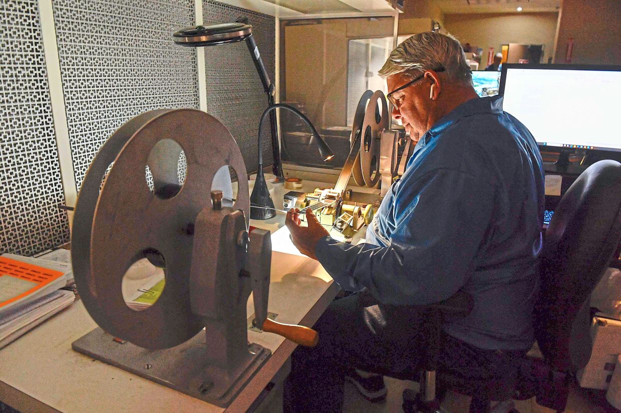 A specialist checking film and making recommendations to clients on how to keep the film in a good shape at Pro-Tek Vaults. — AFP