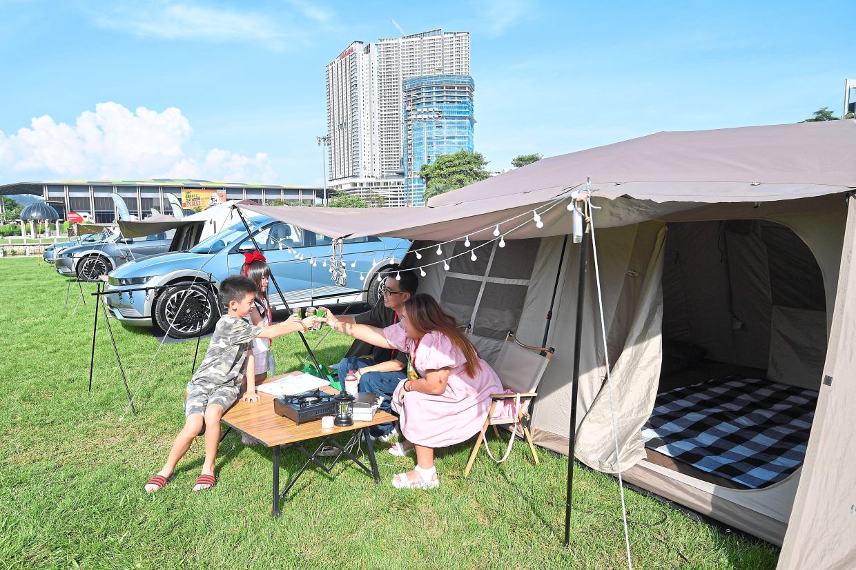 Let’s go camping: CK Gui and his family checking out one of the tents at the expo in Shah Alam yesterday. — IZZRAFIQ ALIAS/The Star