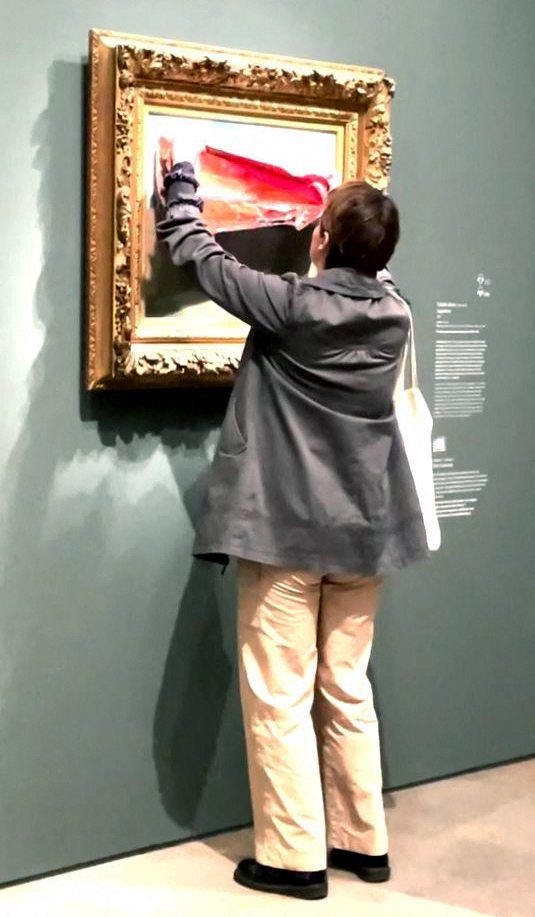 In a video posted on X, a woman is seen placing a blood-red poster over the 'Coquelicots' (Poppy Field) painting by Monet, a French Impressionist artist. Photo: AFP 