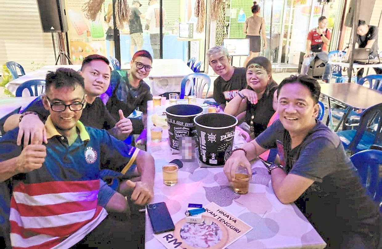 Lester (right) having some drinks with close friends. Lester says the Kaamatan bazaar has never lost its allure as an avenue to bring the people together despite being held without fail each year except during the Covid-19 period.
