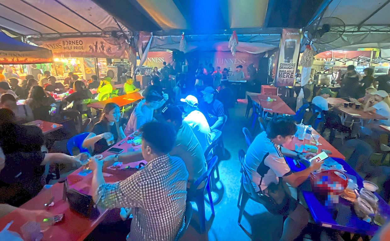 People enjoying their drinks to live music at KDCA in Penampang.