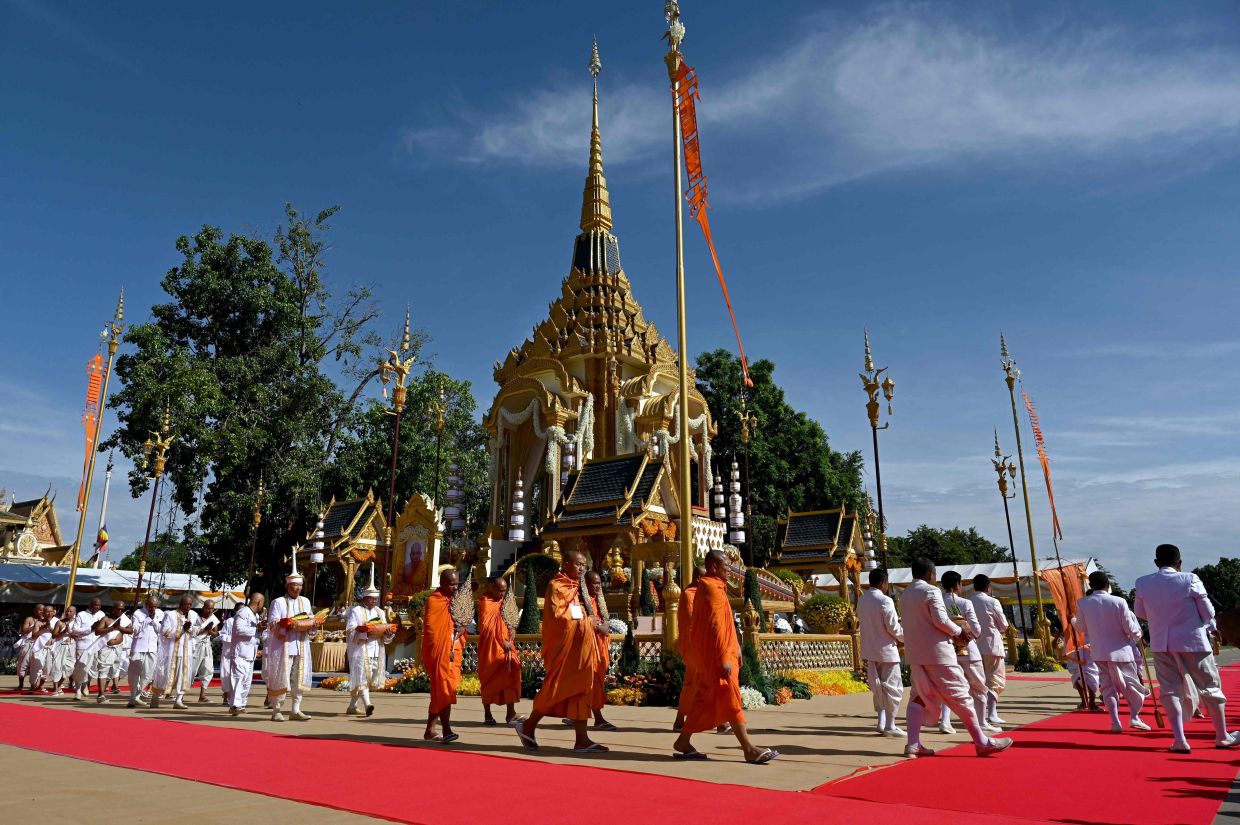 Monks and mourners walk around the crematorium before the cremation of the late Great Supreme Patriarch of Cambodia Tep Vong in Phnom Penh on Monday, June 3, 2024. - AFP