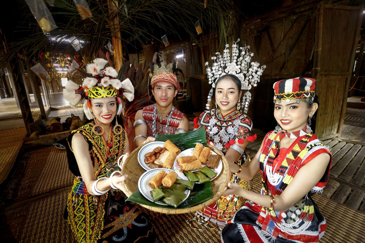 (From left) Enyssa Christeny Freddy, Mohd Sihabuddin Sa\'at, Audreynna Clarissia George and Siti Nur Balqis Marais ready to serve traditional snacks to guests at the Sarawak Cultural Village\'s Gawai open house. — ZULAZHAR SHEBLEE/The Star