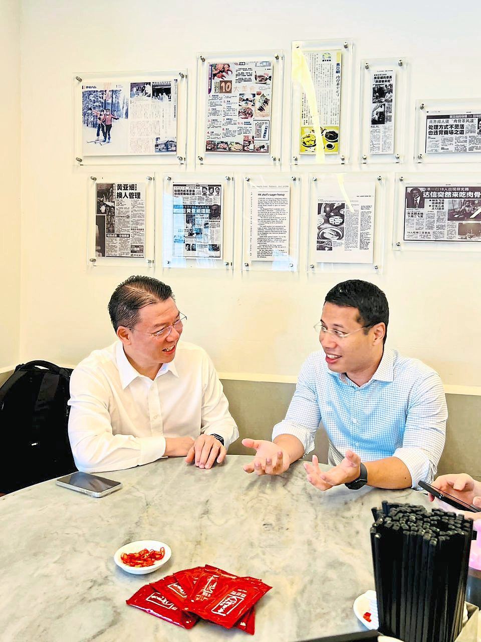 Nga (left) and Lee discussing several issues at a restaurant in Singapore.