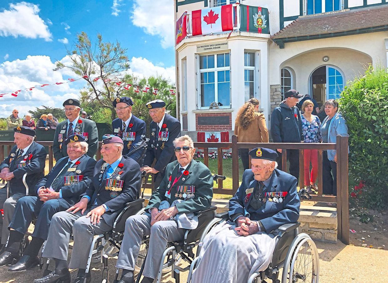 Canadian Veterans in front of THE Canadian House Bernieres-Sur-Mer in June 2029. — MATHILDE LELANDAIS