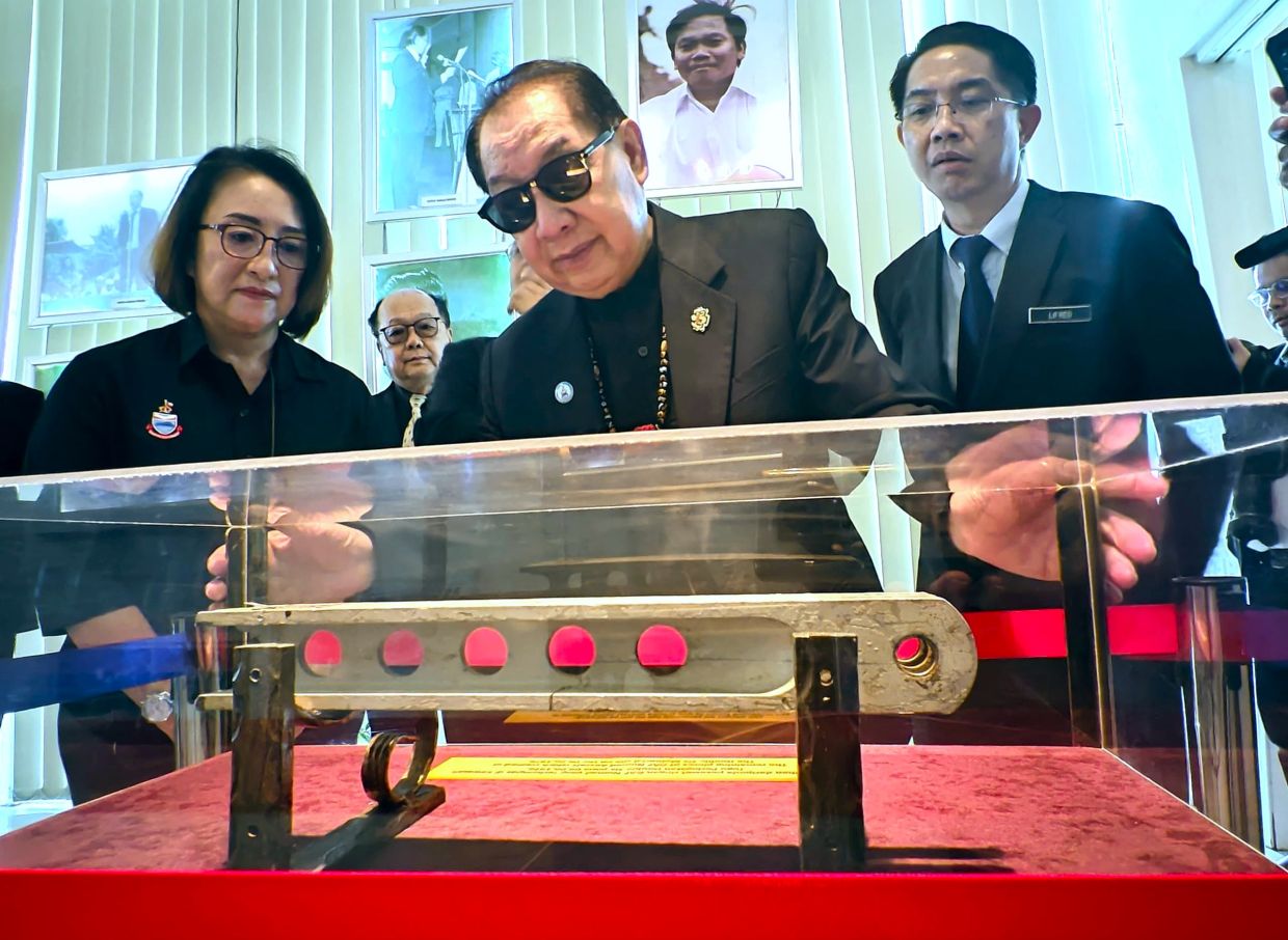 Deputy Chief Minister I Datuk Seri Dr Jeffrey Kitingan taking a closer look at the GAF Nomad Aircraft displayed at the Double Six Gallery in Sembulan on Thursday (June 6).