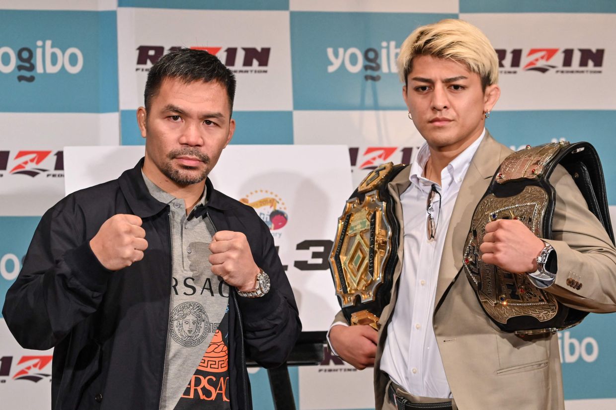 Retired multiple world boxing champion Manny Pacquiao of the Philippines (left) and Japanese kickboxer Chihiro Suzuki pose during a photo session at the end of a press conference at a hotel in Tokyo on Monday, June 10, 2024. It was announced on June 9 that he will fight Japanese mixed martial (MMA) artist Chihiro Suzuki in a three-round boxing match on July 28 in Saitama, north of Tokyo. -  AFP