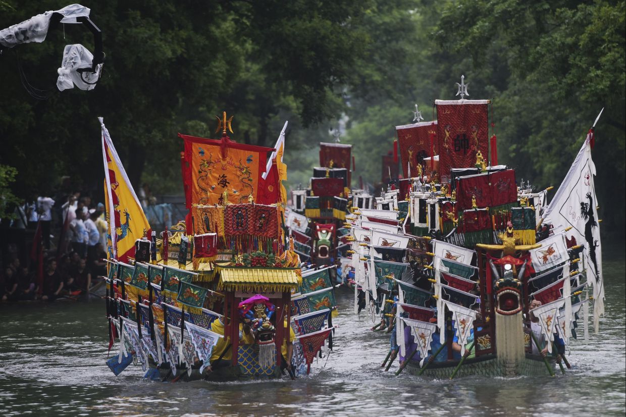 Fancy dragon boats parade in Xixi Wetland to mark the Dragon Boat Festival in Hangzhou in east China's Zhejiang province, Monday, June 10, 2024. The Duanwu Festival, also known as the Dragon Boat Festival, falls on the fifth day of the fifth month of the Chinese lunar calendar and is marked by eating rice dumplings and racing dragon boats.  - Chinatopix via AP
