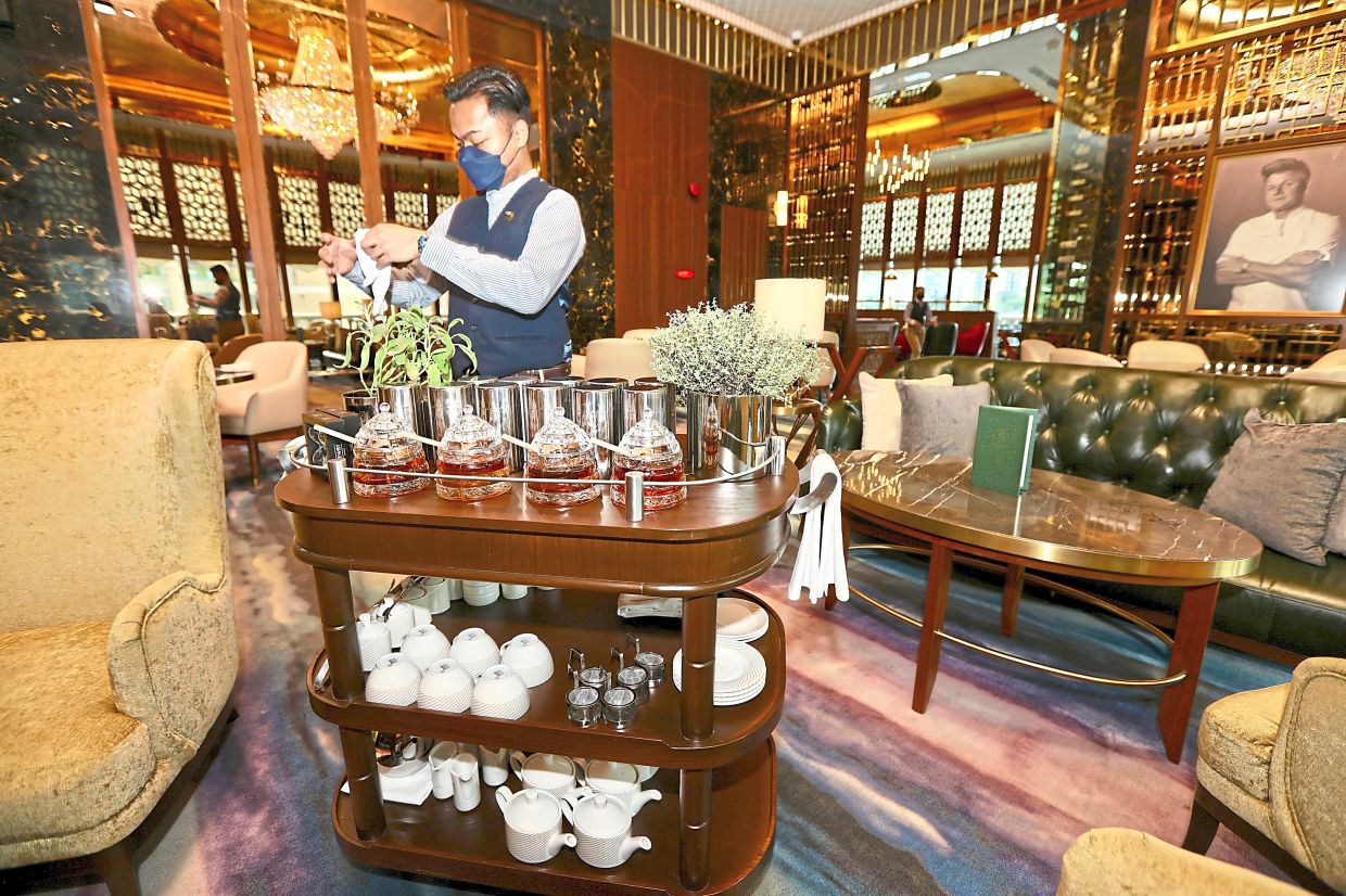 Ahmad Zulhilmi preparing the tea trolley service.