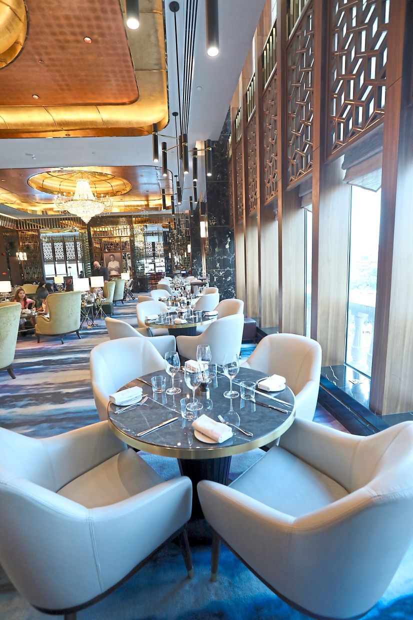 Floor to-ceiling windows frame views of the lagoon at the Gordon Ramsay Bar and Grill.