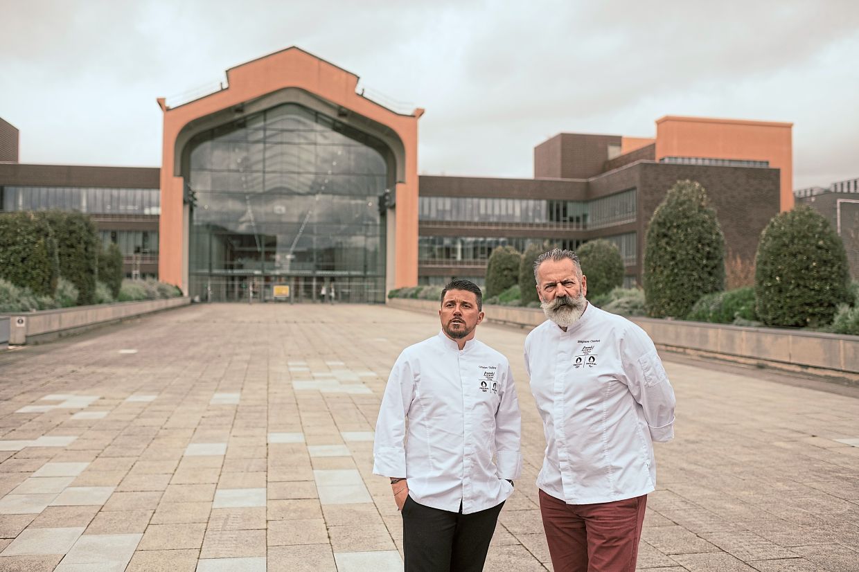 Chefs Guilloy (left) and Chicheri outside the Olympic Village restaurant in Paris, where they will be responsible for serving about 45,000 athletes’ meals a day this summer. — ©2024 The New York Times Company