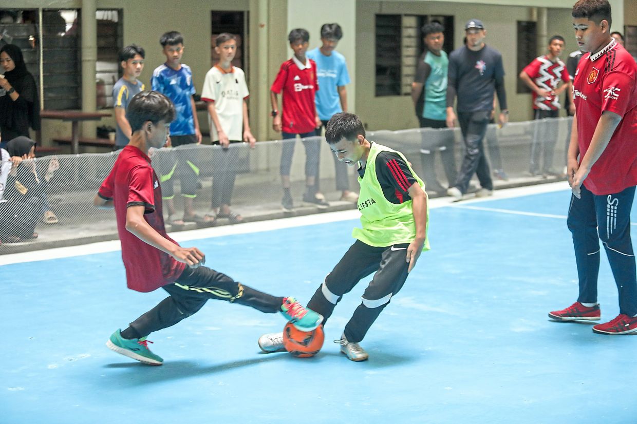 Young participants taking part in a game of futsal.