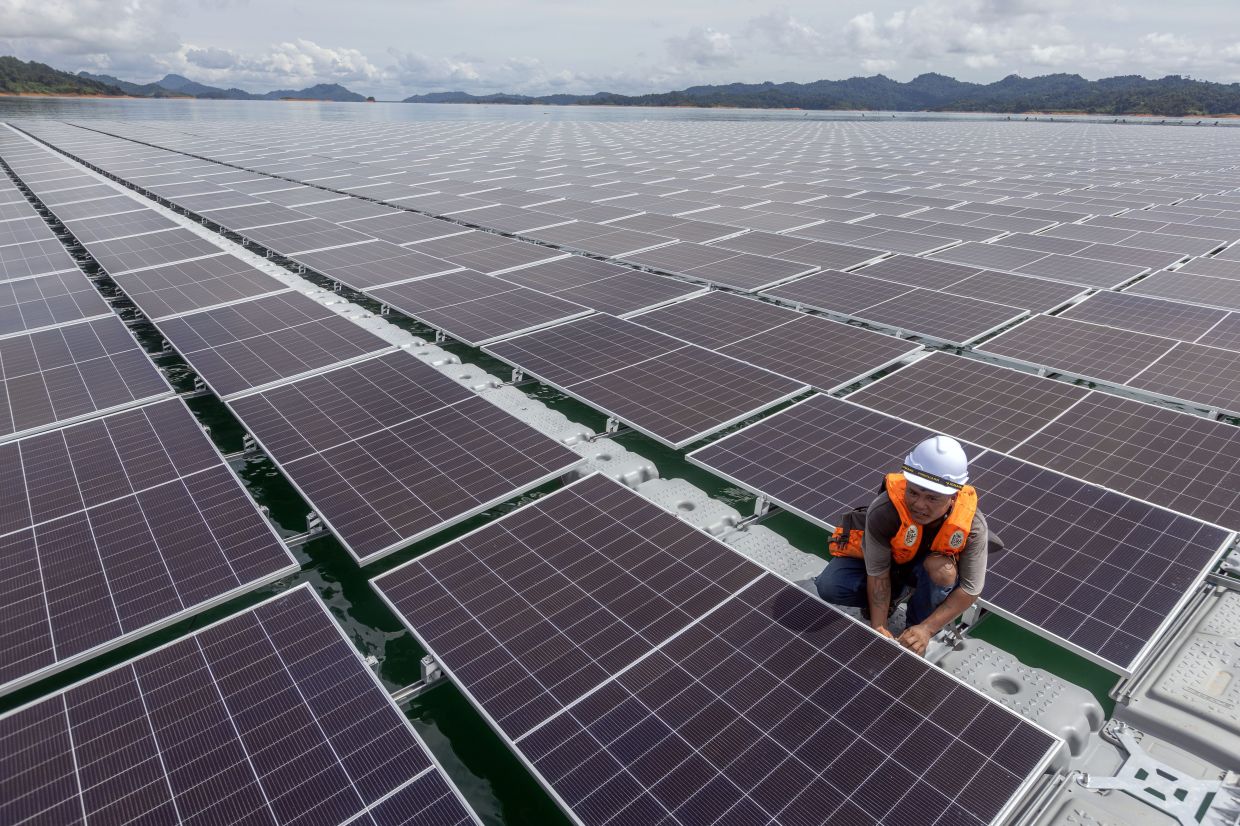 A worker seen at the floating solar farm at the Batang Ai reservoir, Sarawak. The project is scheduled to be completed in October. — ZULAZHAR SHEBLEE/The Star