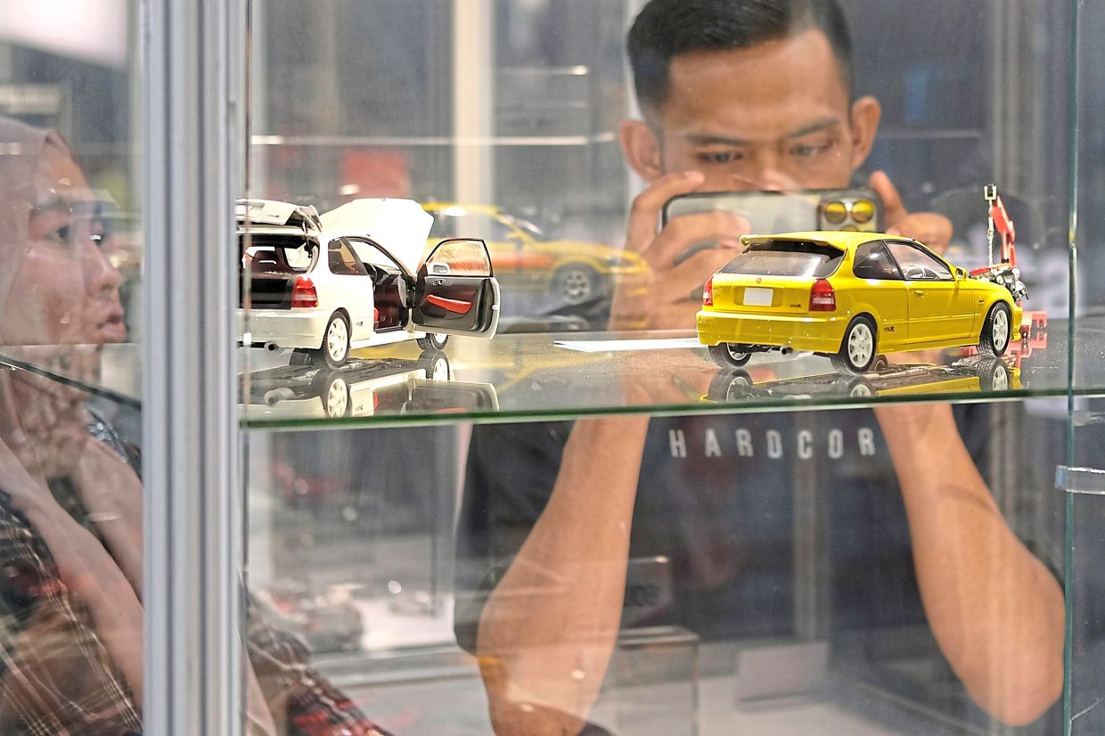 Visitors can’t resist photographing the impressively detailed car models.