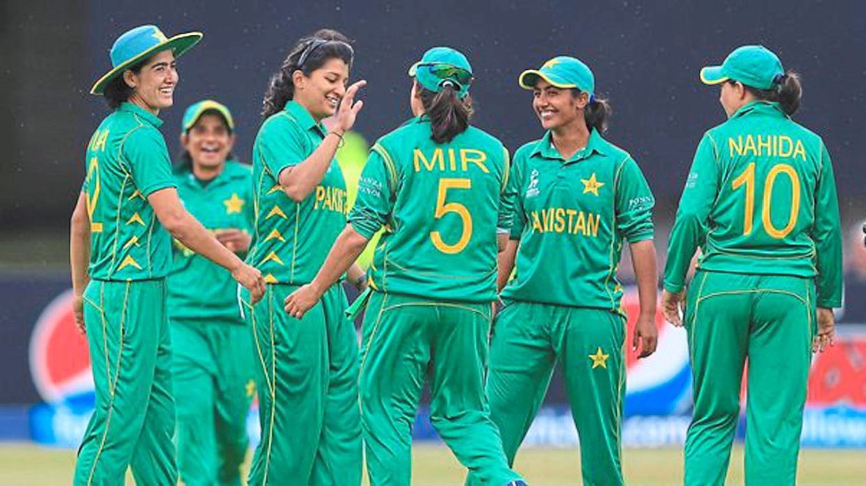 The Pakistan national cricket team celebrating during a match. Female athletes in the country continue to train despite the challenges of extreme heat, lack of safe spaces and cultural limitations.