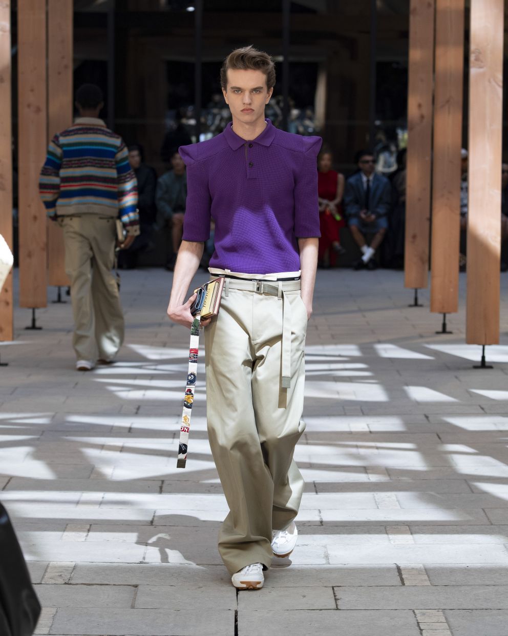 This ensemble comprising a purple polo shirt and khakis, exudes a sense of unstudied sophistication. Photo: Sacai