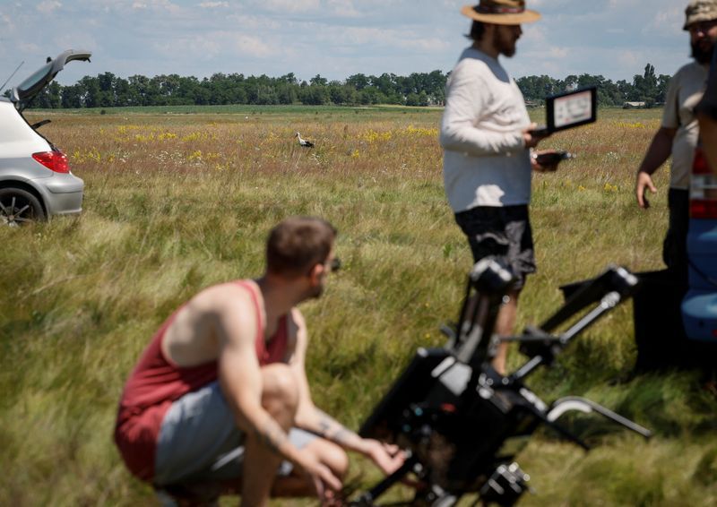 A stork walks across a field as employees of Swarmer company prepare the AI-enabled drone for flight amid Russias attack on Ukraine in Kyiv region Ukraine June 27 2024.  REUTERSGleb GaranichFile Photo