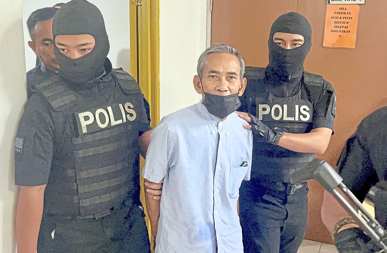 Tight security: Abdullah and Mohamad (pic, below) being escorted by police.