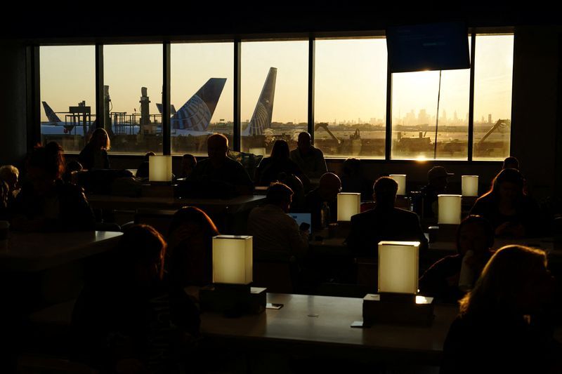 FILE PHOTO Travelers wait for delayed flights beneath a monitor displaying a blue error screen also known as the Blue Screen of Death inside Terminal C in Newark International Airport after United Airlines and other airlines grounded flights due to a worldwide tech outage caused by an update to Crowdstrikes quotFalcon Sensorquot software which crashed Microsoft Windows systems in Newark New Jersey U.S. July 19 2024. REUTERSBing GuanFile Photo