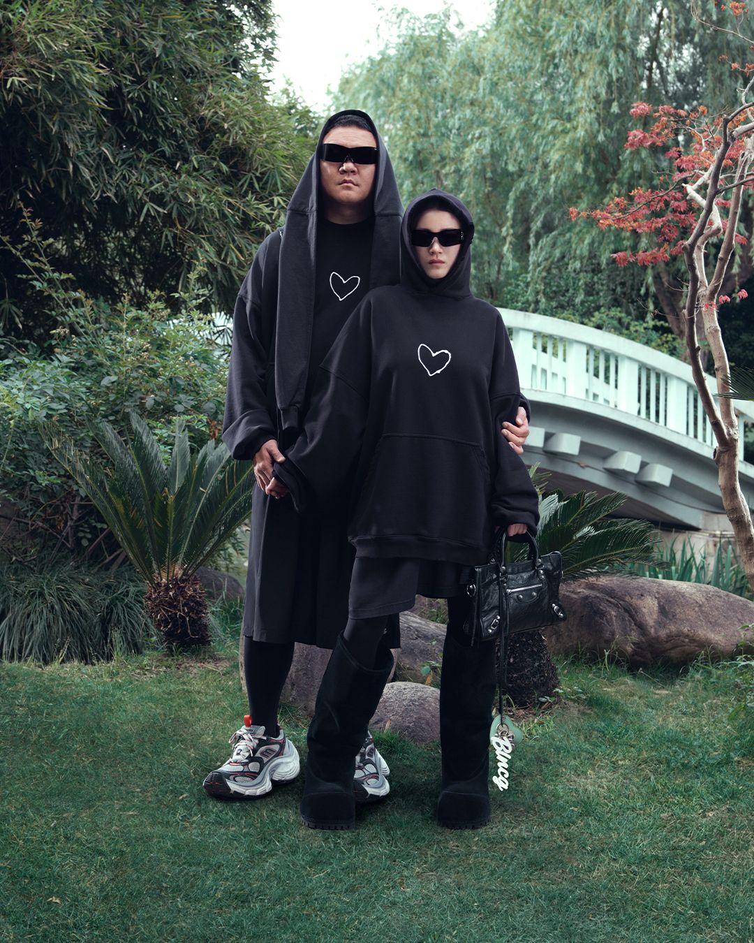The campaign features couples posing in various settings, including a botanical garden. Photo: Balenciaga