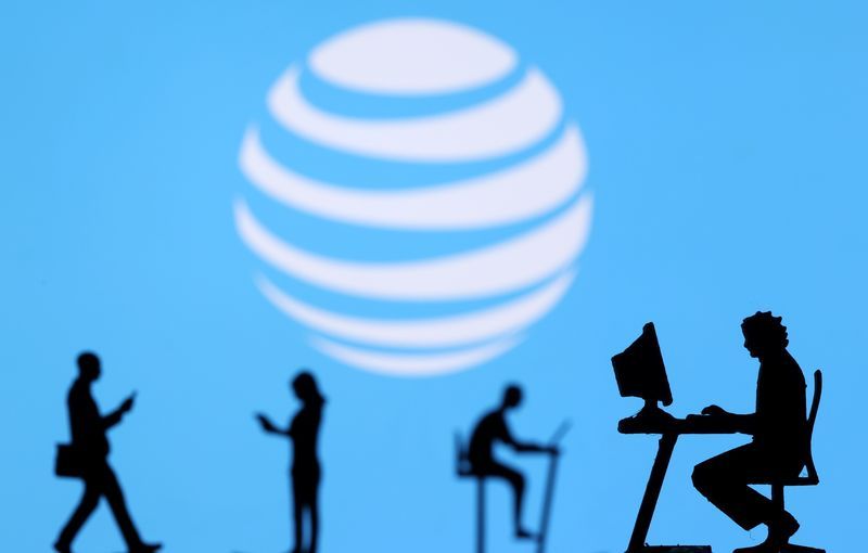 FILE PHOTO Small toy figures with laptops and smartphones are seen in front of displayed ATampT logo in this illustration taken December 5 2021. REUTERSDado RuvicIllustrationFile Photo