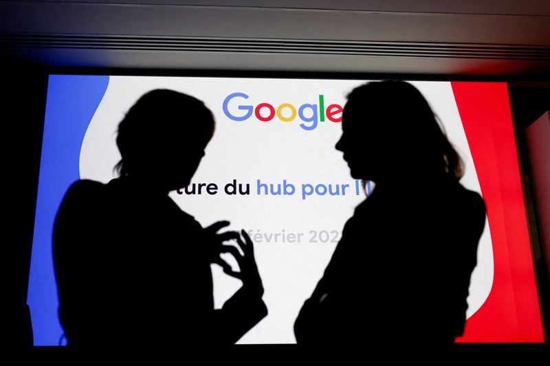 FILE PHOTO People are silhouetted in front of a Google logo during the inauguration of a new hub in France dedicated to the artificial intelligence AI sector at the Google France headquarters in Paris France February 15 2024. REUTERSGonzalo FuentesFile Photo